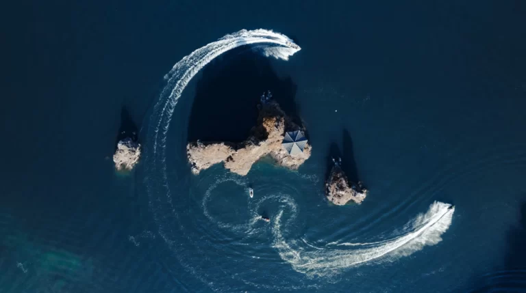 Boats in the ocean circling island Financial Freedom Financial Planning